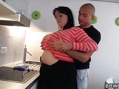 Horny guy fucks busty plumper at the kitchen