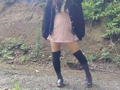 Japanese crossdresser pees openly in the forest for a selfie.